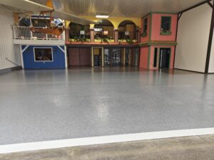 2400 sq ft of a two color flake in this hanger in North Hampton, NH Commercial Concrete Coating by Epoxy Pros of New England-min