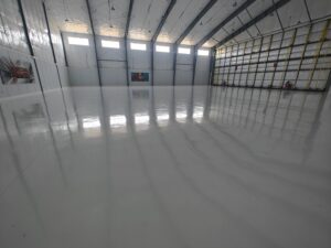 Hanger - 15,000 sq ft of white epoxy with aliphatic urethane top coat at Sanford Seacoast Regional Airport by Epoxy Pros of New England-min